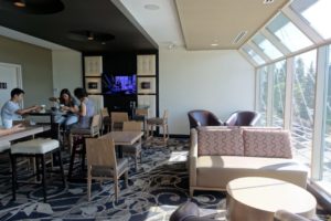 a room with a window and chairs and tables