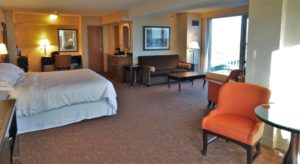 a hotel room with a bed and chairs