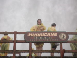 a group of people wearing yellow raincoats standing on a bridge