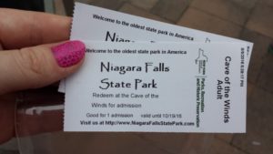a hand holding two tickets