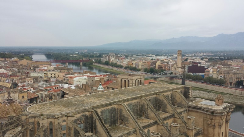 a city with a river and mountains in the background