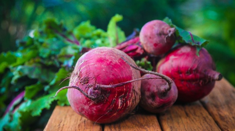 a group of red beets on a table