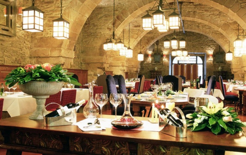 a restaurant with a stone arch and stone walls