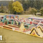 a large inflatable playground on a river