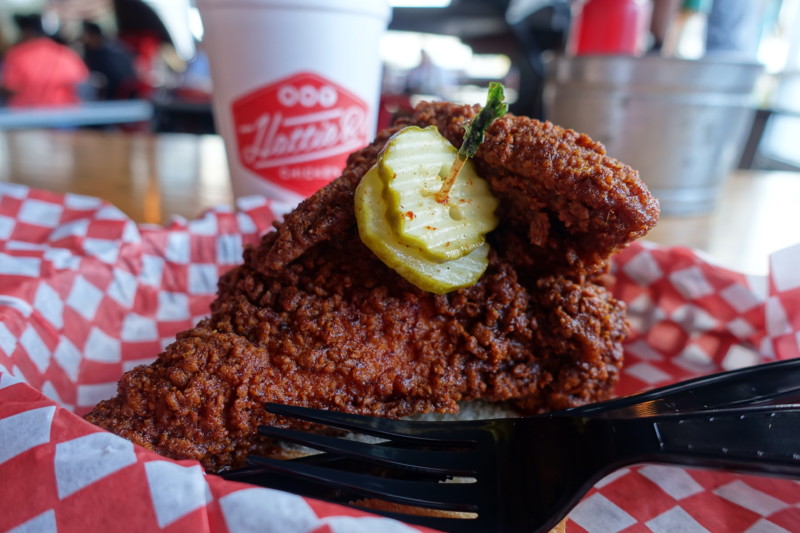 a fried chicken with a pickle on top
