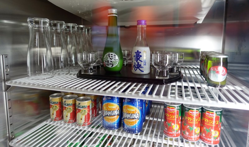 a refrigerator full of drinks and glasses