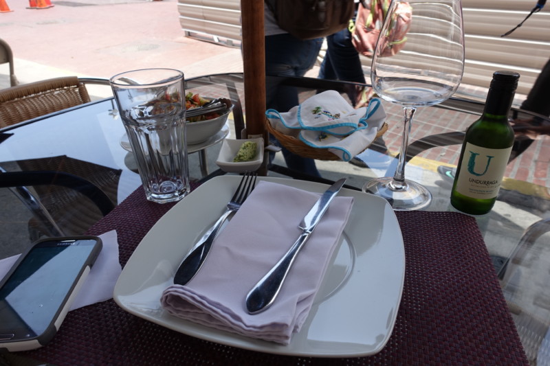a plate with silverware and glasses on a table