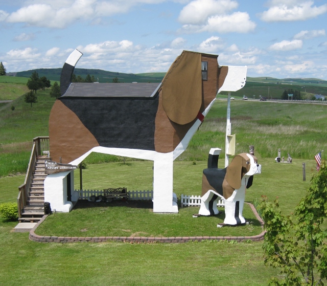 a large dog statue in a grassy field