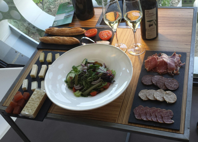 a plate of salad and wine glasses on a table