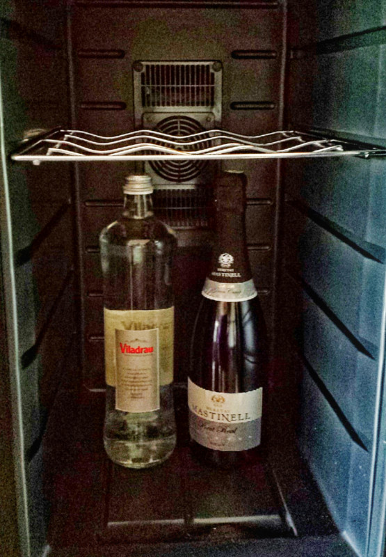 two bottles of wine inside a refrigerator