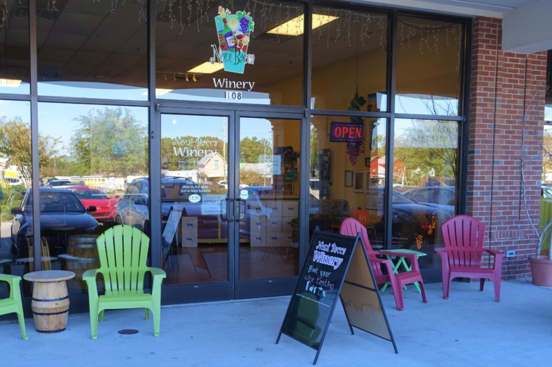 a store front with chairs and signs
