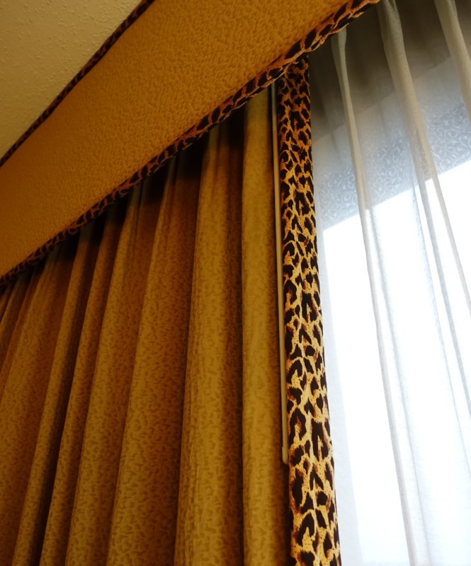 a curtain with leopard print trim