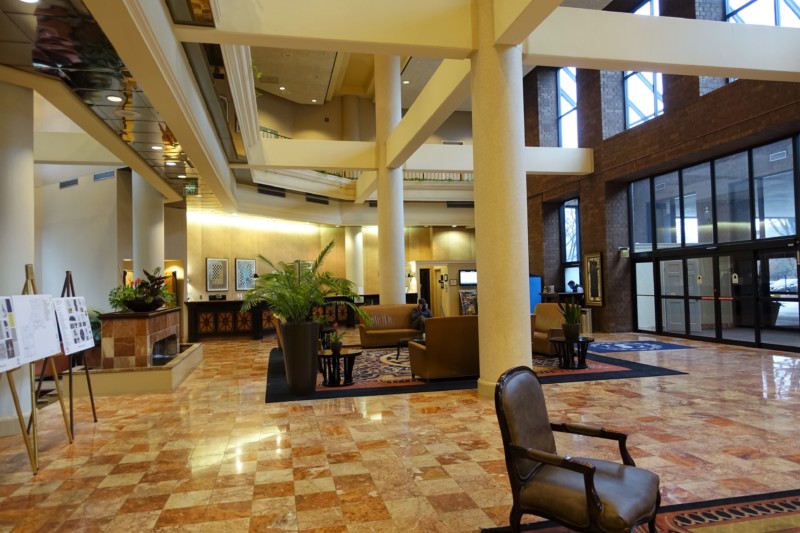 a large lobby with a chair and a fireplace