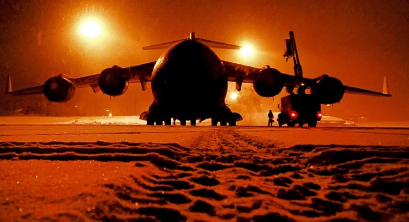 a large airplane on a runway at night