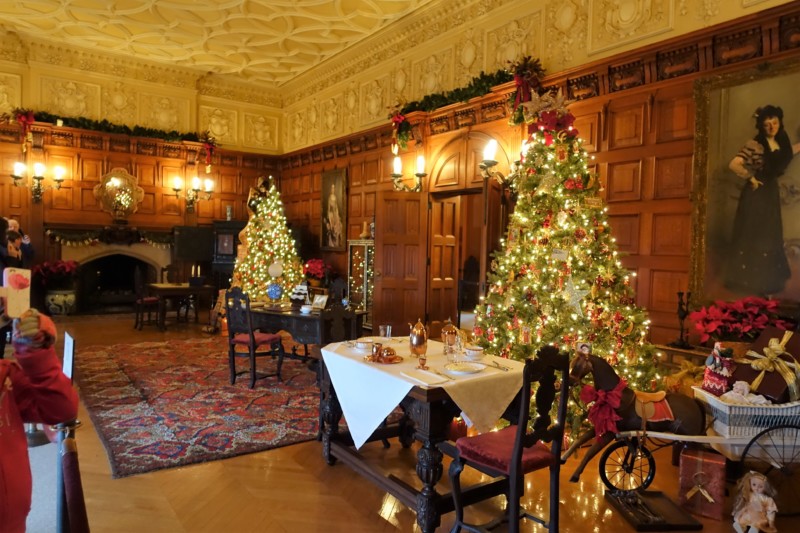 a room with a decorated tree and a table