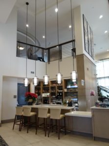 a bar with stools and lights from the ceiling