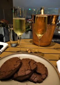 a plate of cookies and champagne on a table