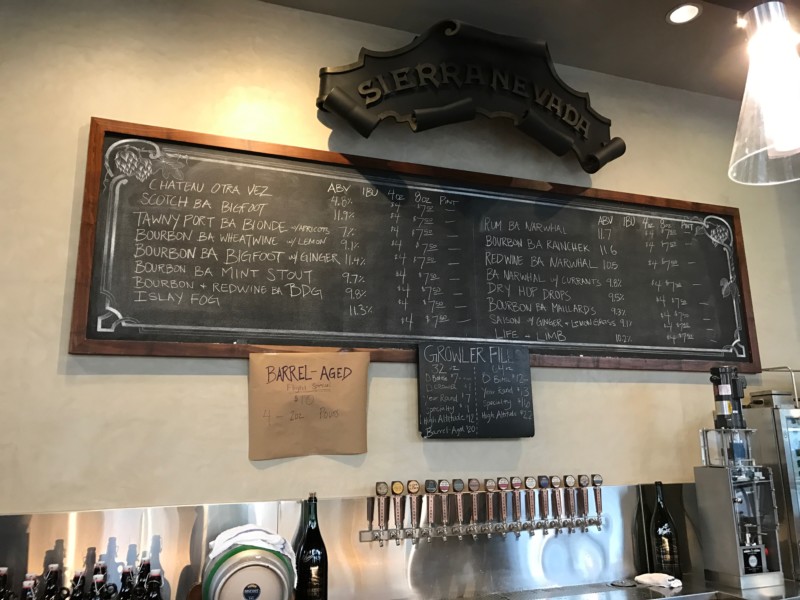 a menu board with a sign on the wall