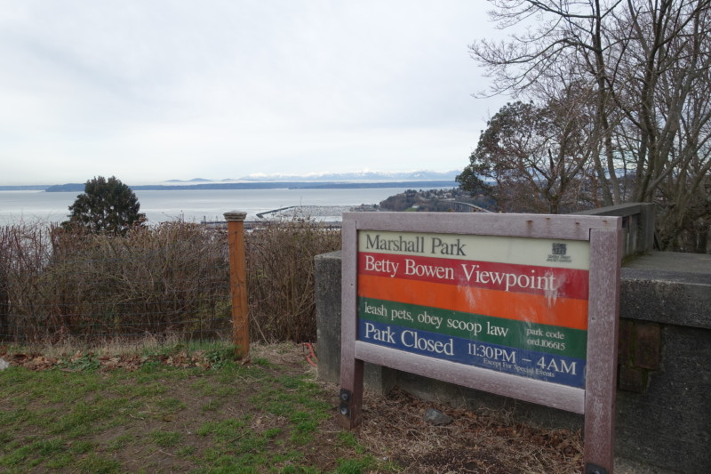 a sign with a body of water in the background