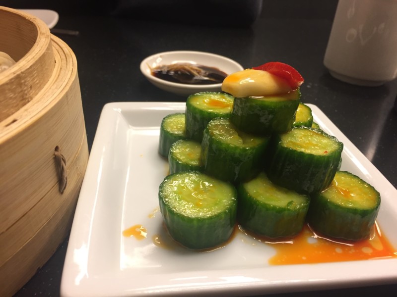 a plate of cucumbers on a black surface