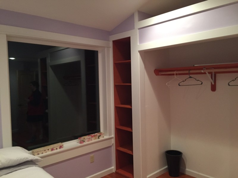 a closet with shelves and a window
