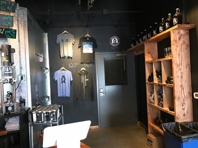 a room with a door and shelves with beer cans and a shelf with a door