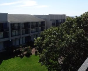 a building with trees and grass