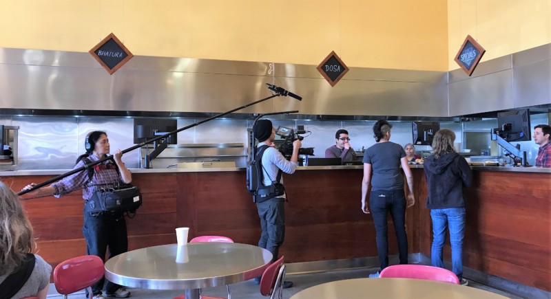 a group of people standing around a counter