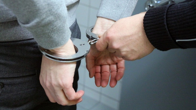 a close-up of hands in handcuffs