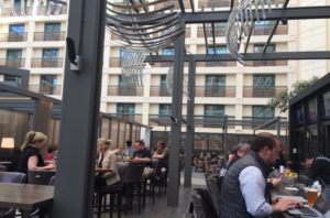 a group of people sitting at tables in a restaurant