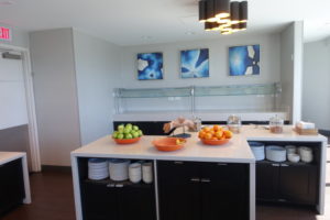 a kitchen with a counter top and bowls of fruit