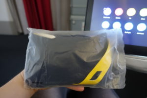 a hand holding a bag of black and yellow objects