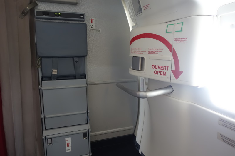 an airplane door with a red arrow