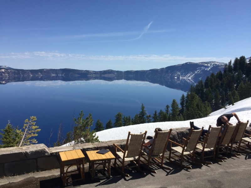 a group of chairs and tables overlooking a body of water