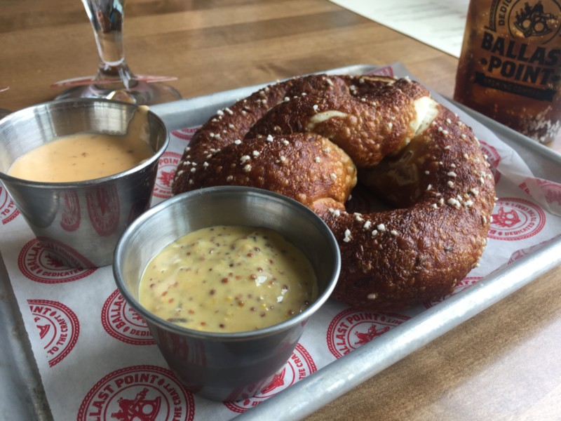 a pretzel and dip on a tray