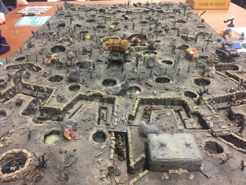 a game board with a group of people and a hole in the ground