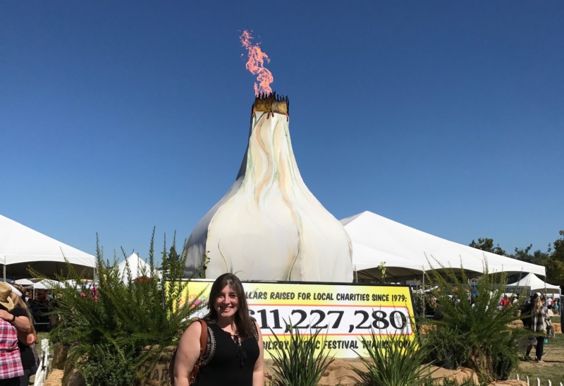 a woman standing in front of a sign with a large white onion