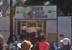 a group of people standing outside a food truck