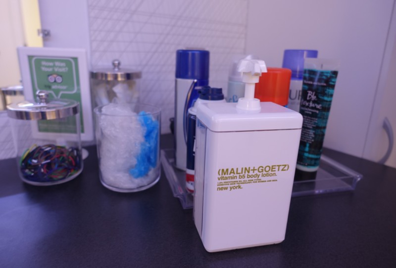a white container with a pump on a counter