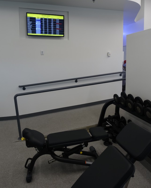 a gym with weights and a monitor
