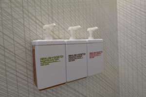 a group of soap dispensers on a wall