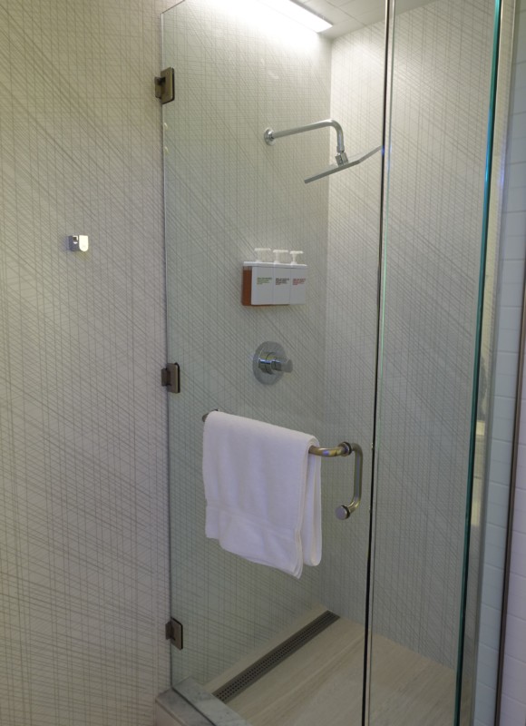 a shower with a towel on a bar