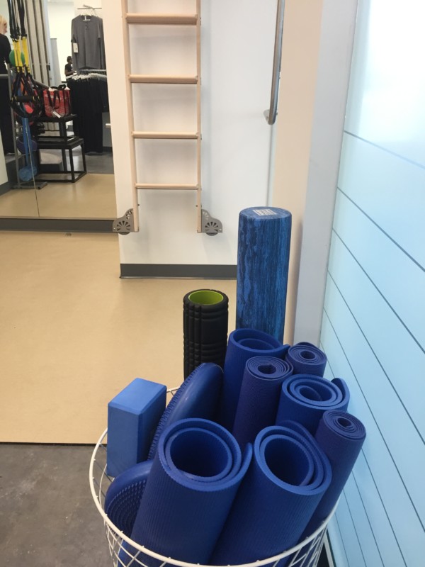 a basket of yoga mats and a ladder
