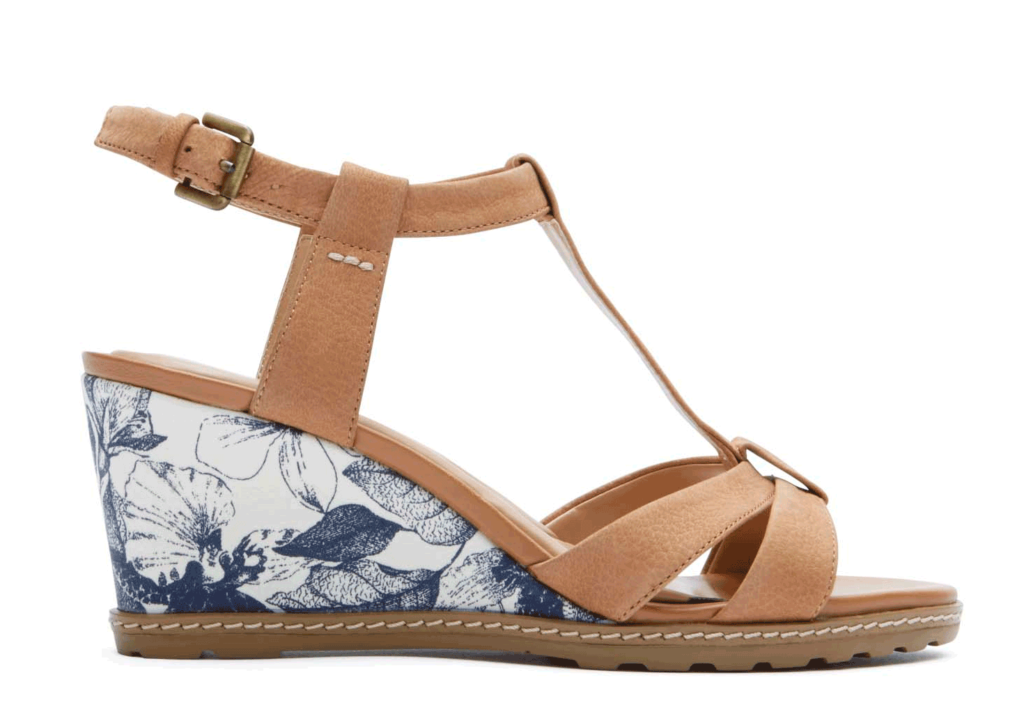 a brown and white wedge sandal with blue and white flowers on it