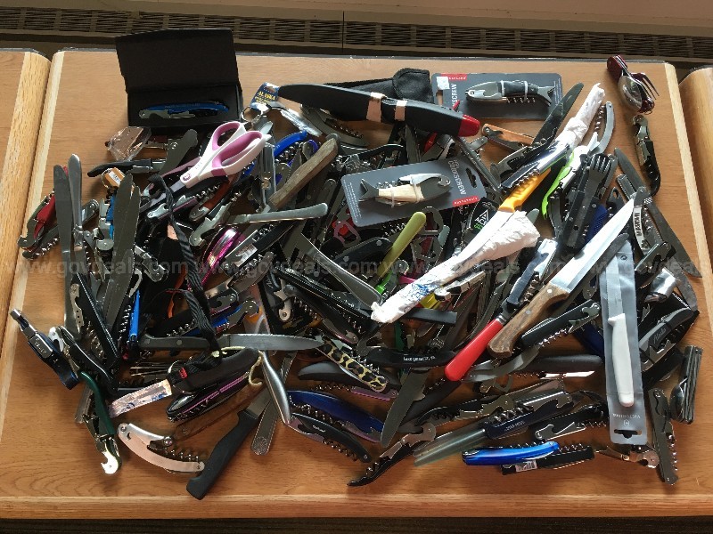 a large pile of multi-tool knives