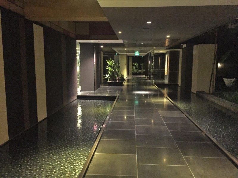a hallway with a pool and a walkway