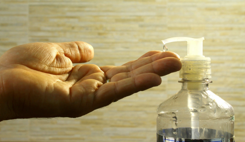 a person using a hand sanitizer