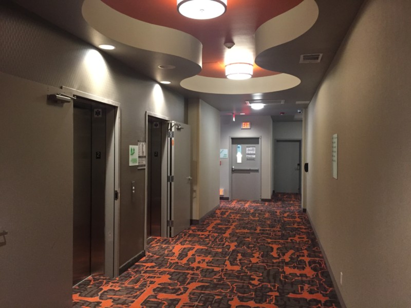 a hallway with doors and a ceiling