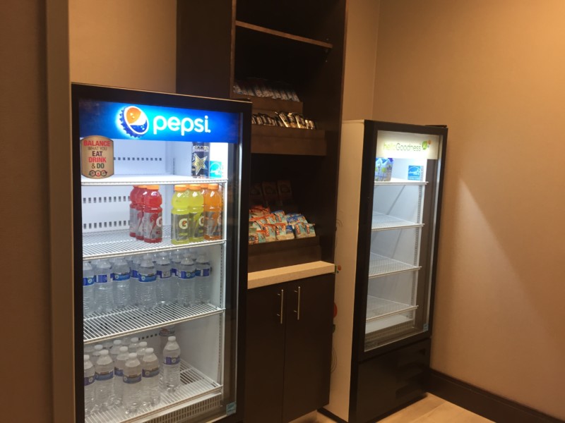 a refrigerator and beverage cooler in a room
