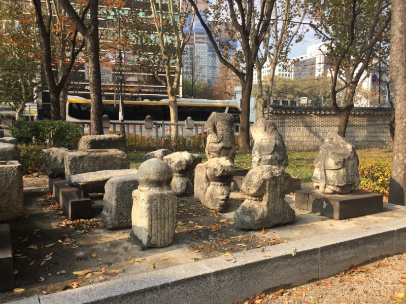 a group of stone statues in a park